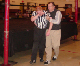 Tommy Young assists referee Jamie Tucker